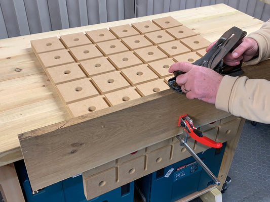 HDS Hold Down System with quick ratchet clamp securing timber on a portable workbench
