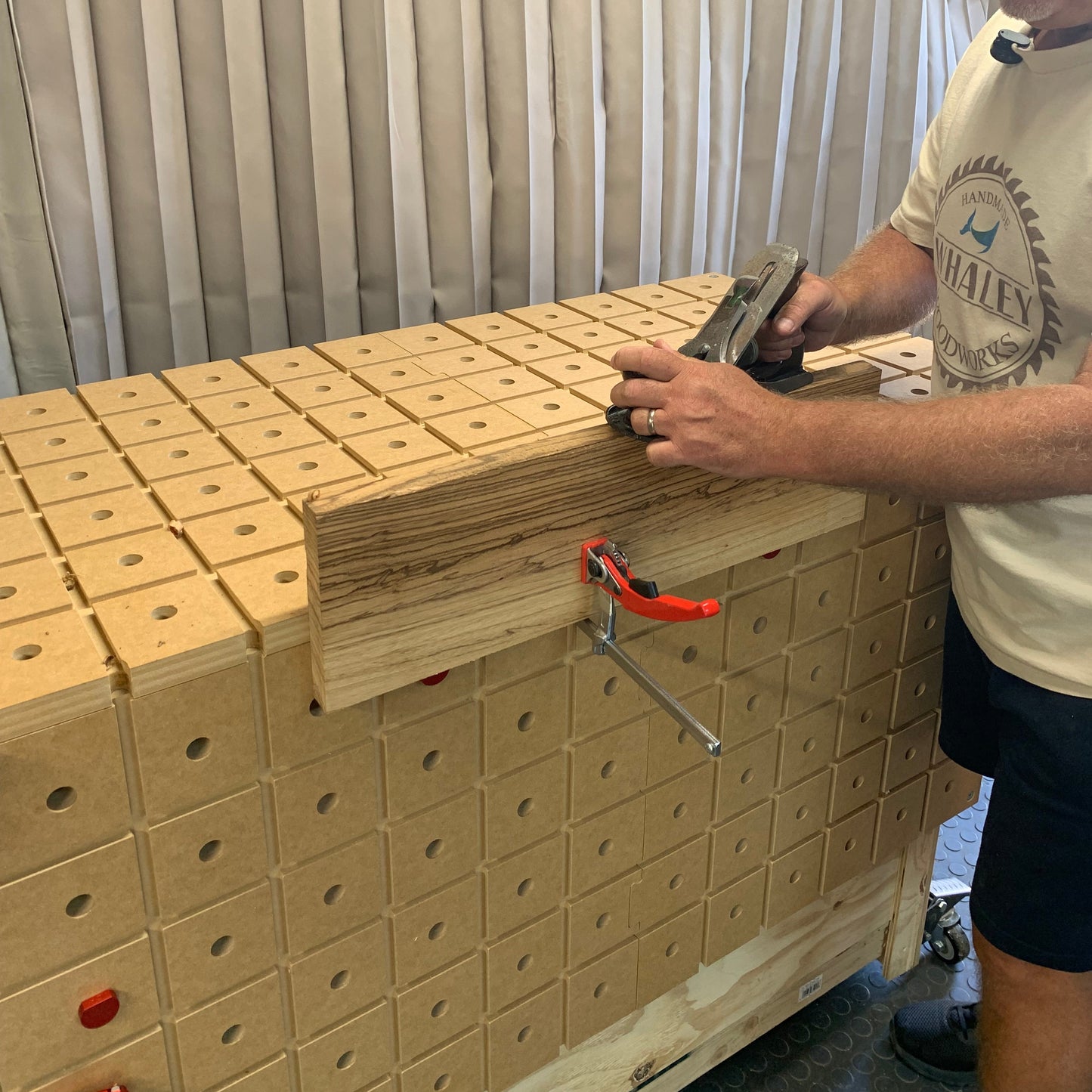 HDS Workbench Top Master Pack – woodworker hand planing a board clamped to the hold down system workbench top, made in the UK