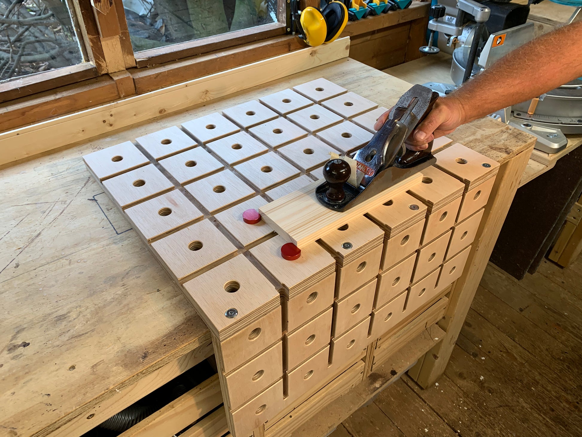 Flattening material using a hand plane and the Grade B HDS Hold Down System wooden workbench for DIY and woodwork enthusiasts