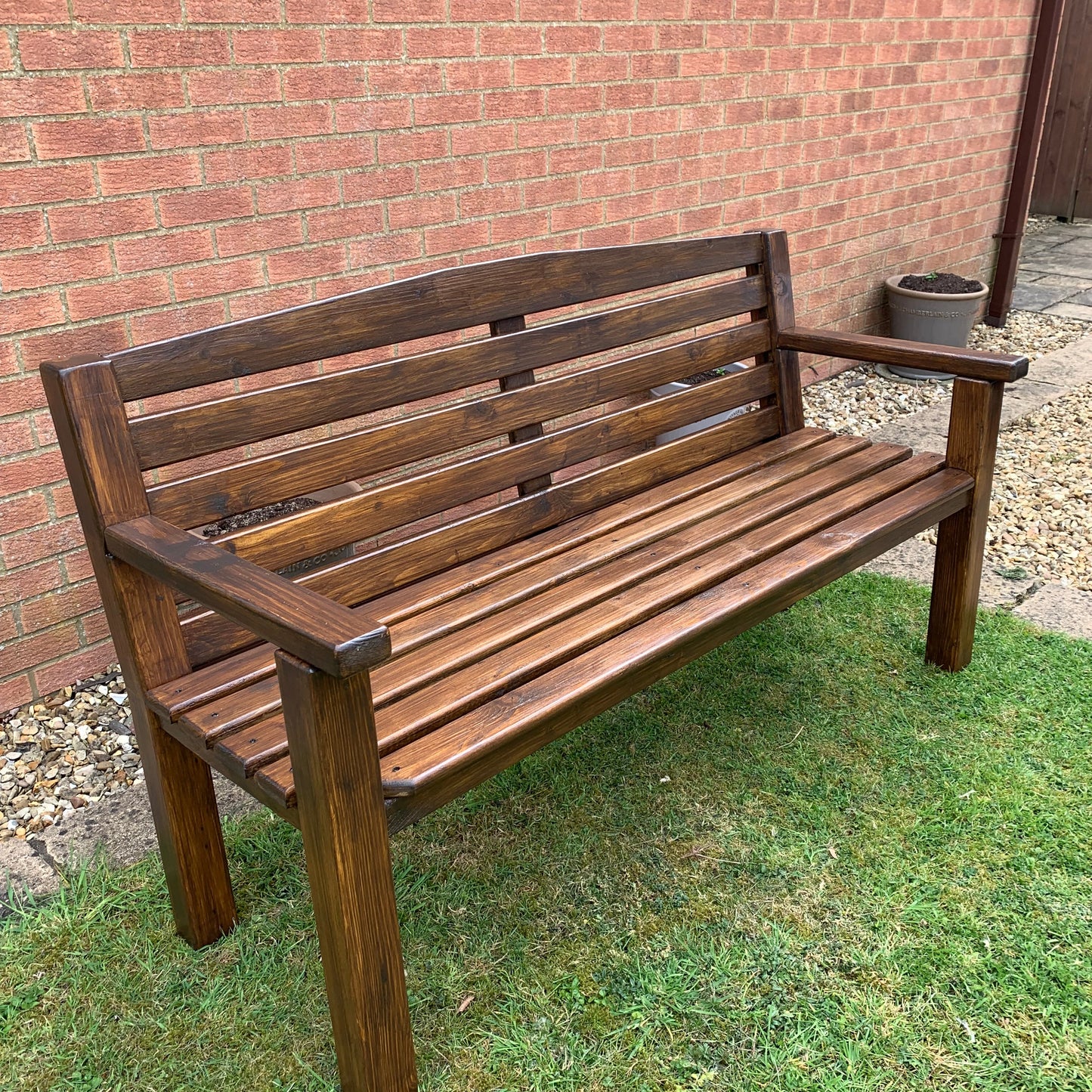 Dark oak garden bench angled view, handmade outdoor seating UK