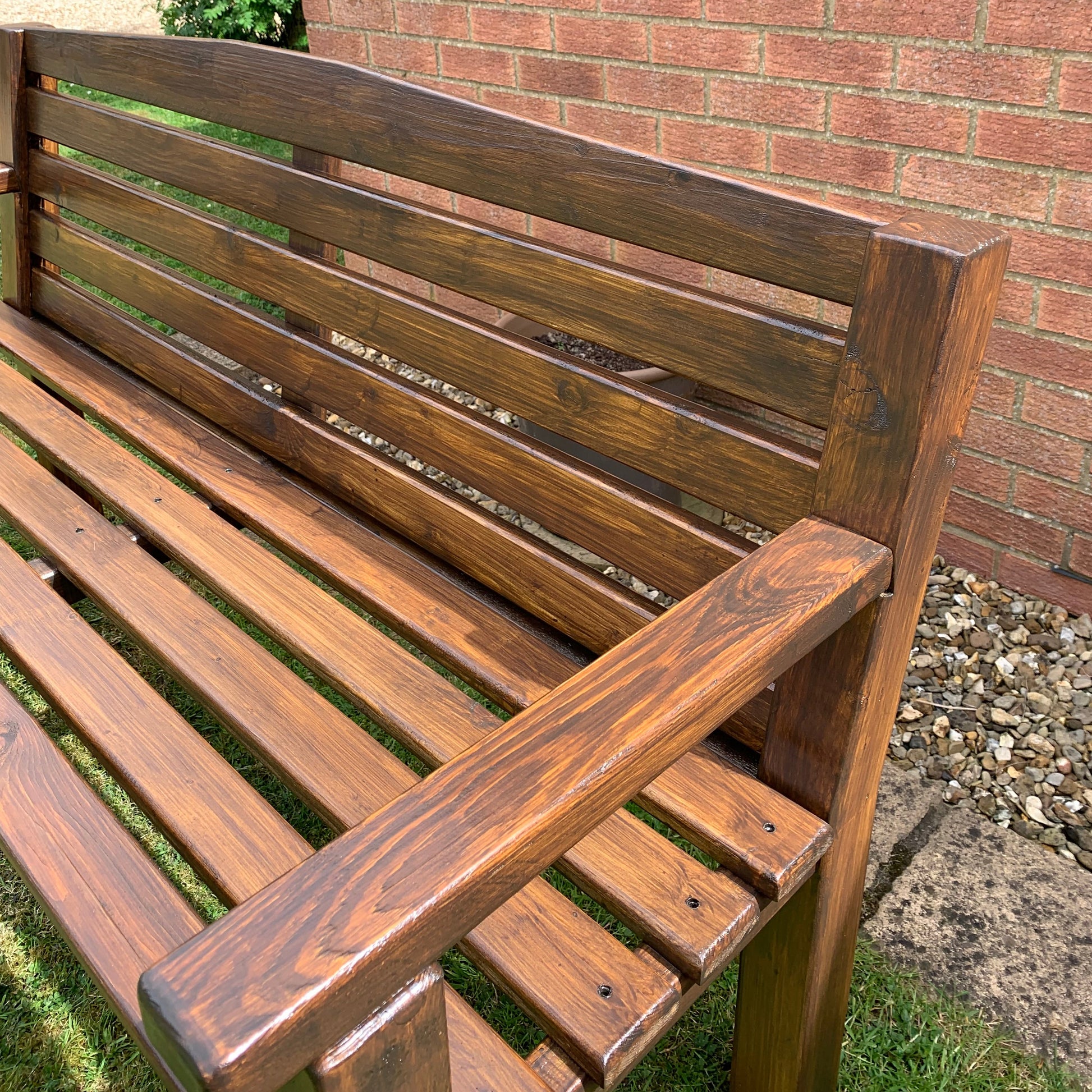 Dark oak garden bench close-up, pressure-treated timber finish