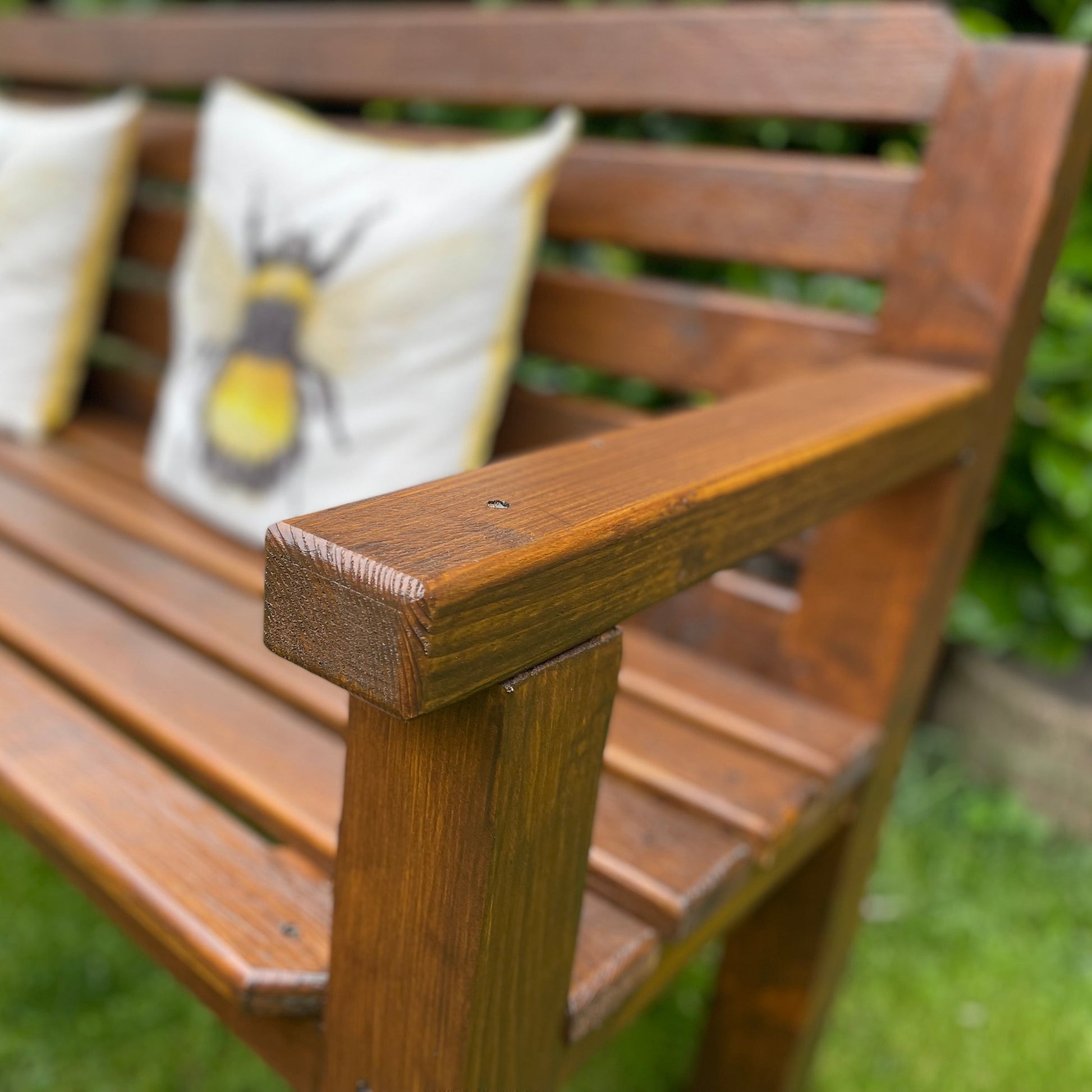 Dark oak garden bench leg and frame close-up, solid timber joinery
