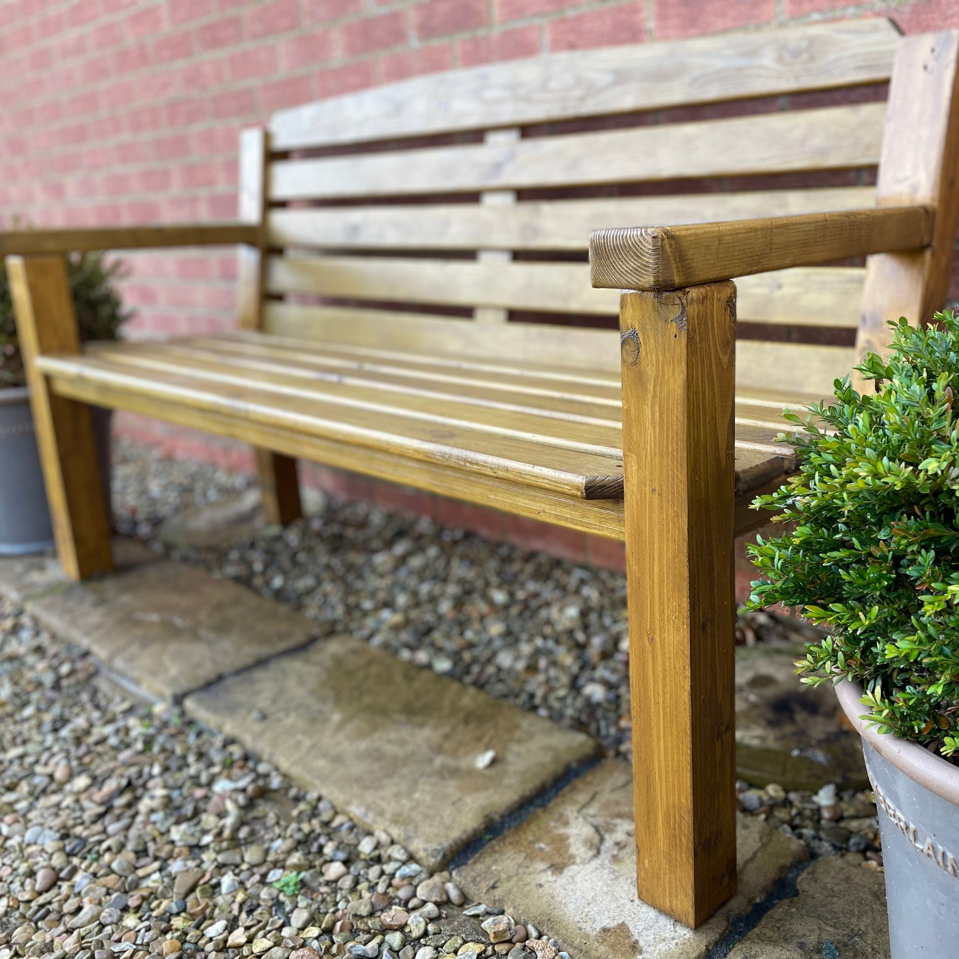 Garden bench in medium oak on a patio