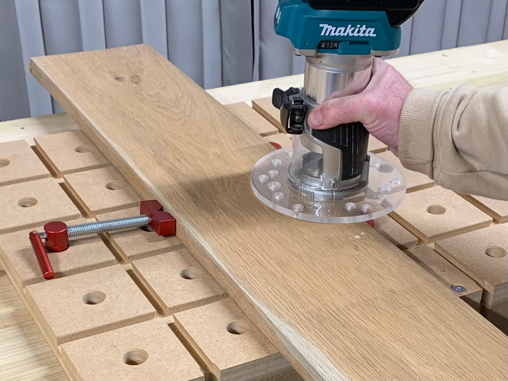 Woodworker using the HDS Hold down system with a Makita DRT50Z Router 