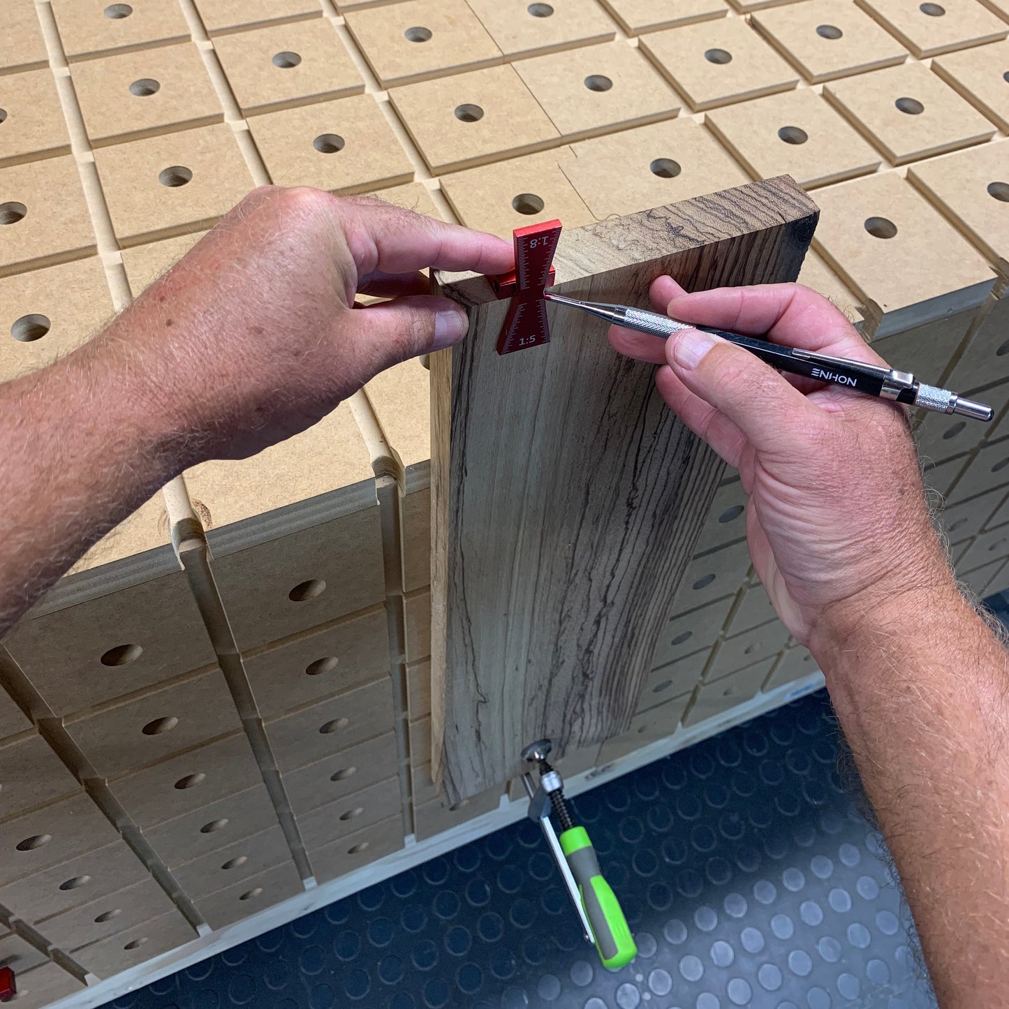 HDS Workbench Top dovetail marking gauge scribing a board clamped vertically against the hold down system workbench top, made in the UK