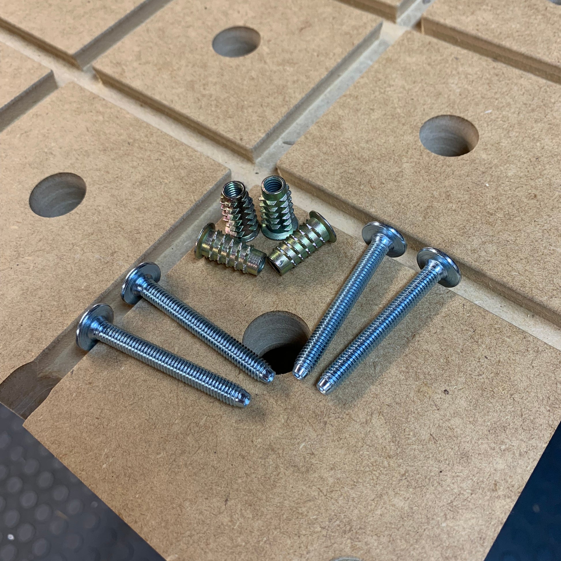 HDS Fixing Kit bolts and threaded inserts arranged on an HDS Workbench Top surface with dog holes