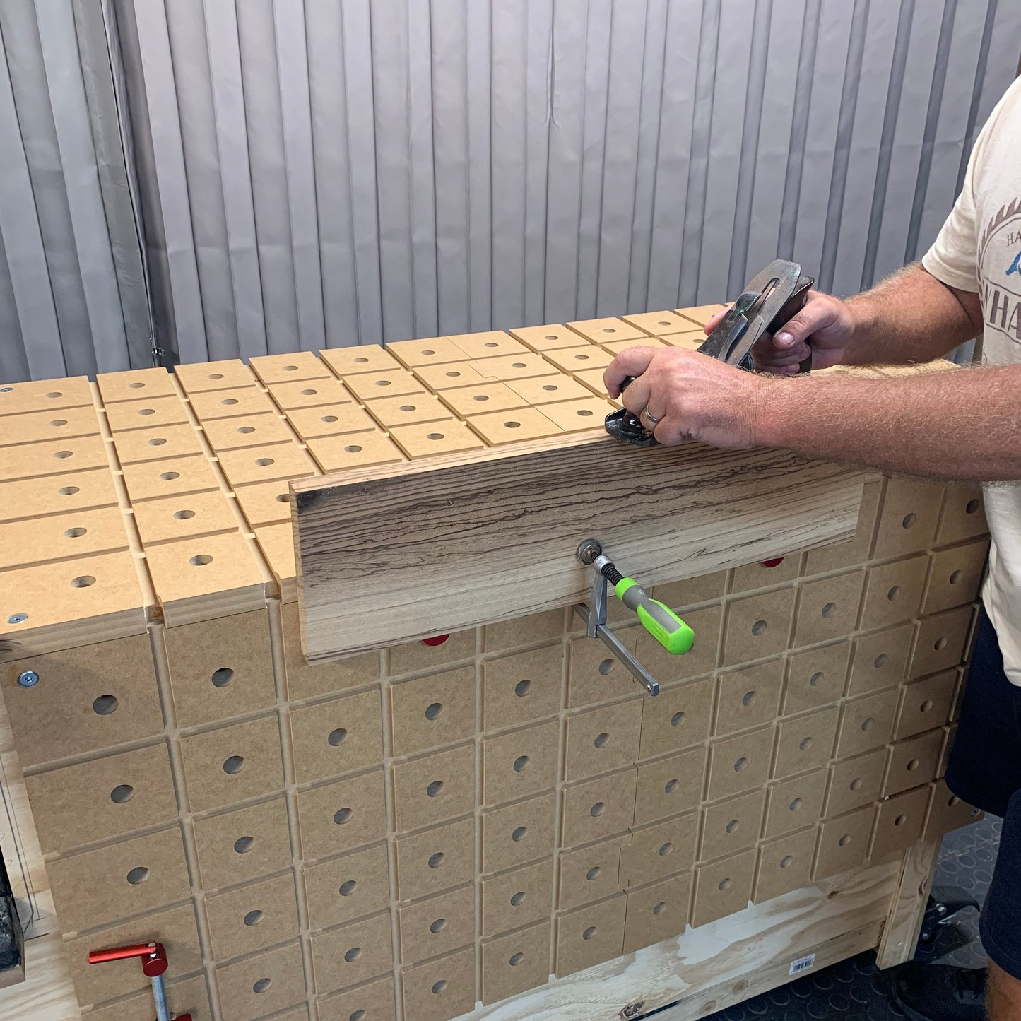 HDS Workbench Top – Stanley plane jointing the edge of a board clamped to the hold down system workbench top, made in the UK