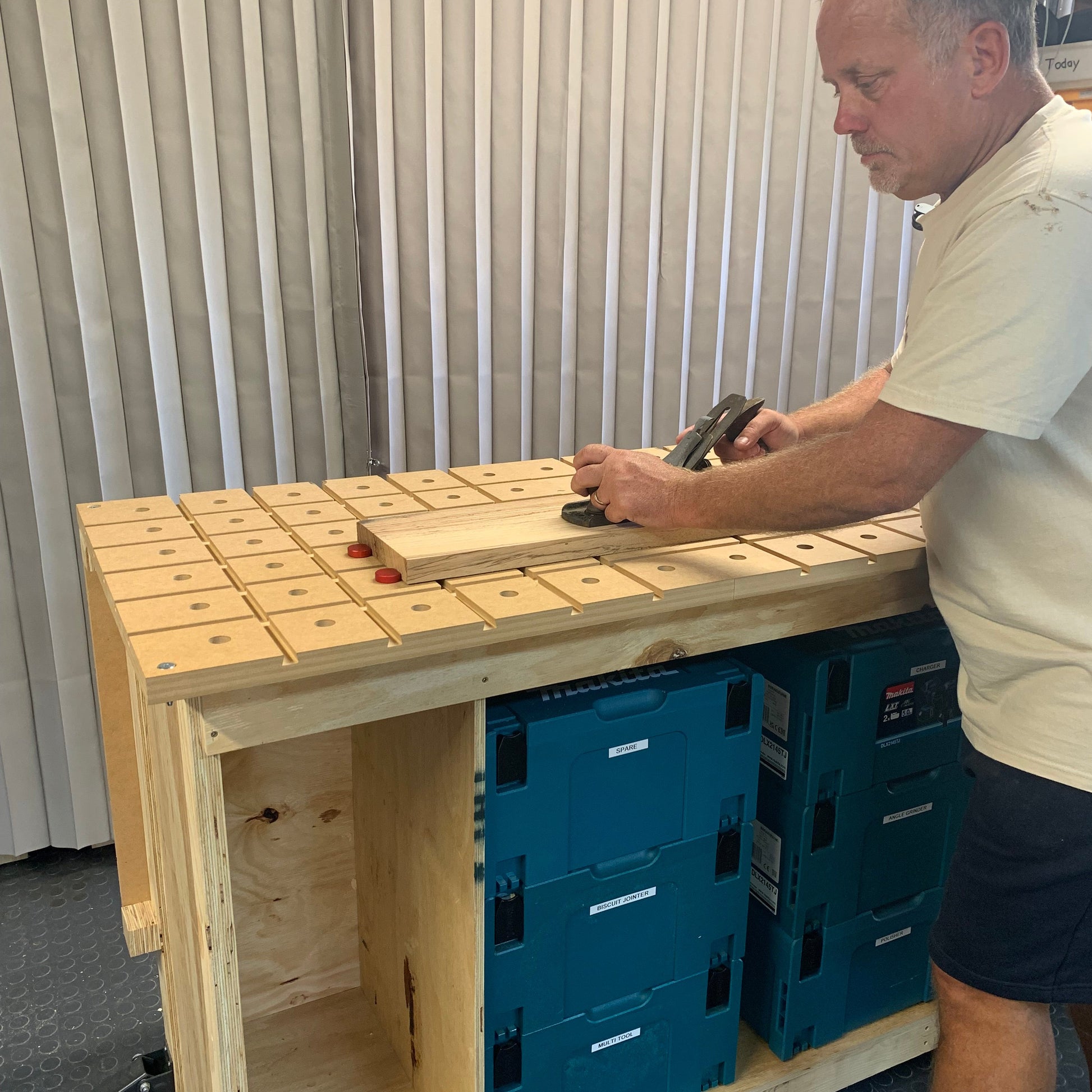 HDS Workbench Top – woodworker using the hold down system workbench top in the workshop, made in the UK