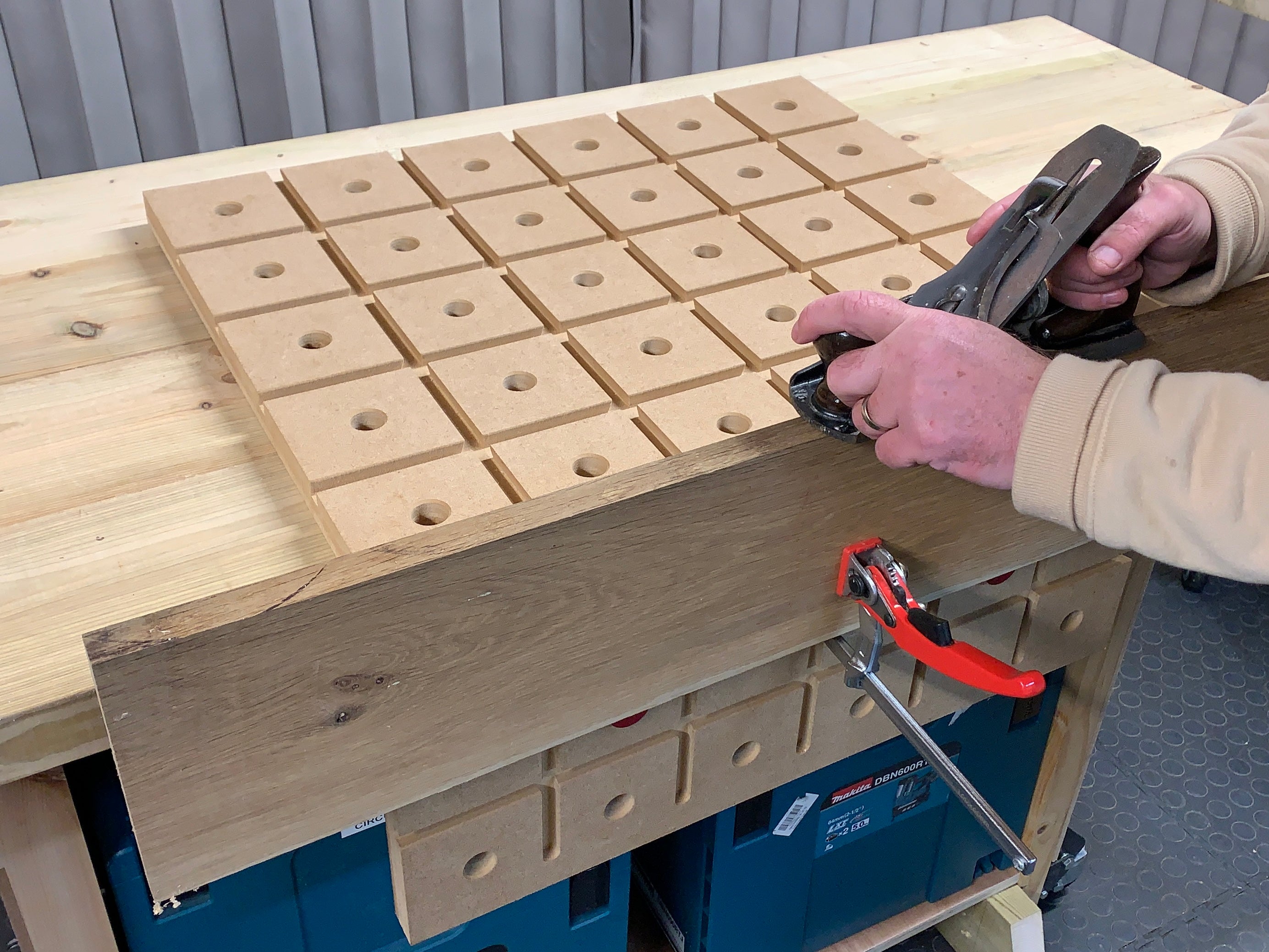 Hand planing wood on HDS portable woodworking bench with quick clamp