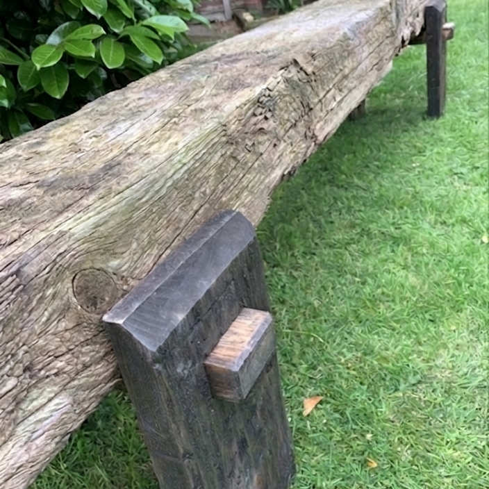 Sleeper bench legs on grass, dark oak finish