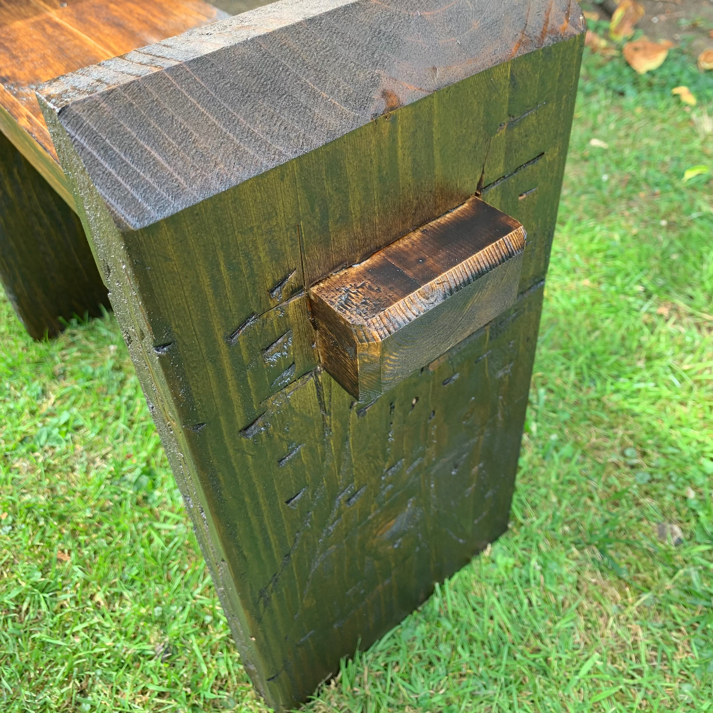 Dark oak bench leg bracket close-up, heavy-duty fixing