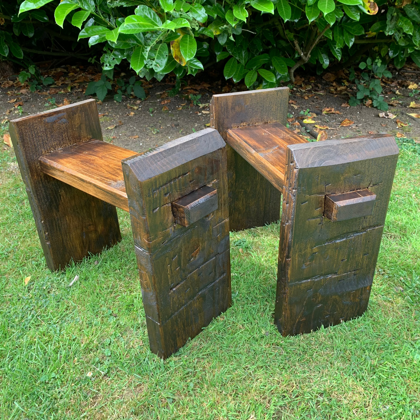 Sleeper bench legs angled view, dark oak finish