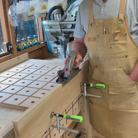 Video showing a woodworker securing a portable MFT style workbench to his bench